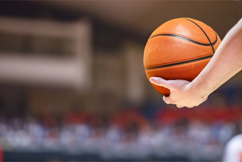 An arm holding a basketball