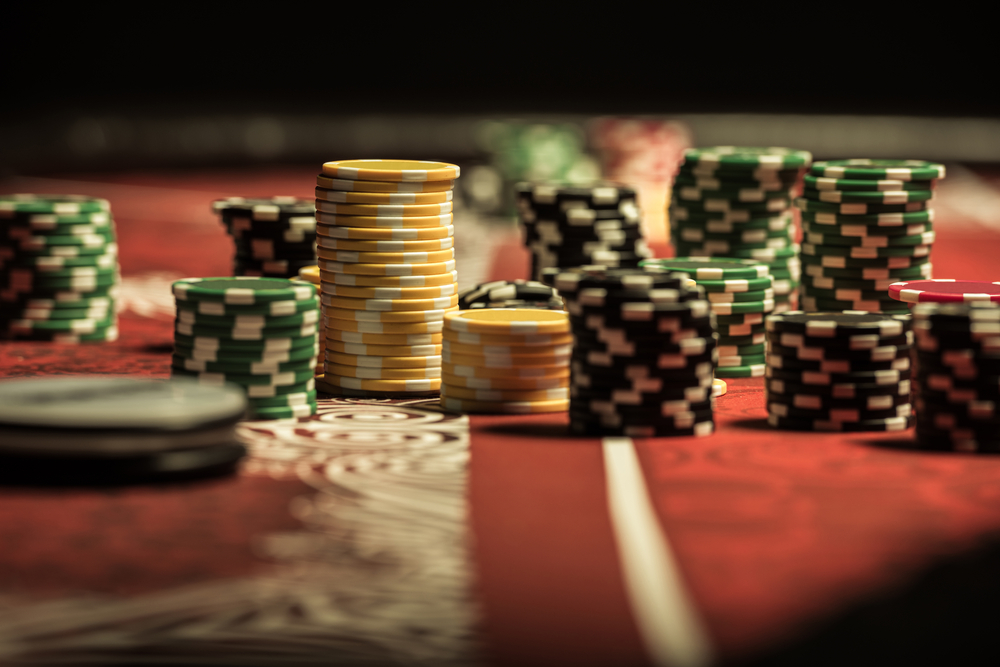 close-up shot of poker chips on red-felt table