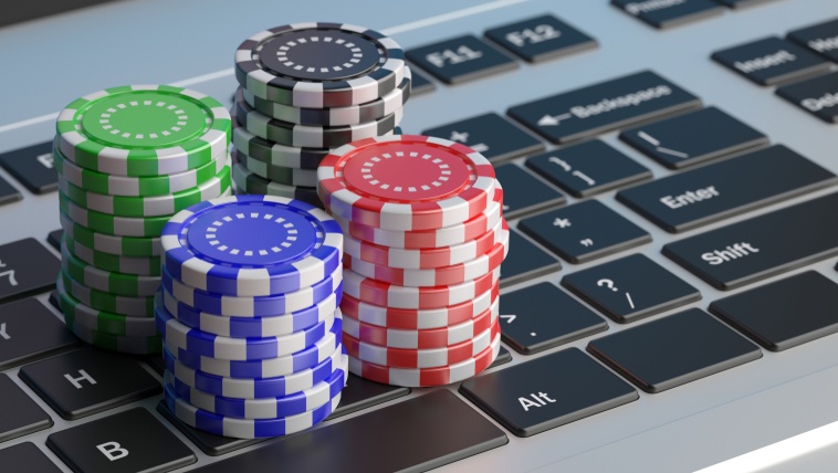 stacks of euro poker chips on laptop keyboard