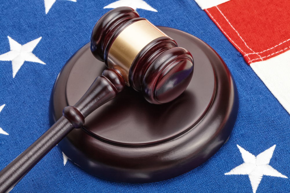 judge's gavel placed on US flag